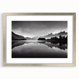 Framed wall art featuring a serene landscape of a tranquil lake, surrounded by lush greenery, with a silver mat and frame, ideal for home decor enhancement.