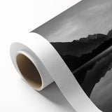 Rolled canvas artwork showcasing a serene lake landscape, featuring vibrant blues and greens, ideal for home decor, packaged securely for delivery.