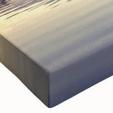 Close-up of a vibrant stretched canvas wall art piece depicting a serene lake landscape, featuring rich blues and greens that evoke tranquility, perfect for home decor.