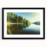Framed wall art showcasing a serene lake landscape with vibrant colors and intricate details, featuring a sleek black frame and white mat for a modern touch.