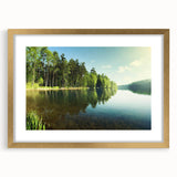 Framed wall art featuring a serene lake landscape design with a gold mat, highlighting vibrant blues and greens, perfect for enhancing home decor aesthetics.