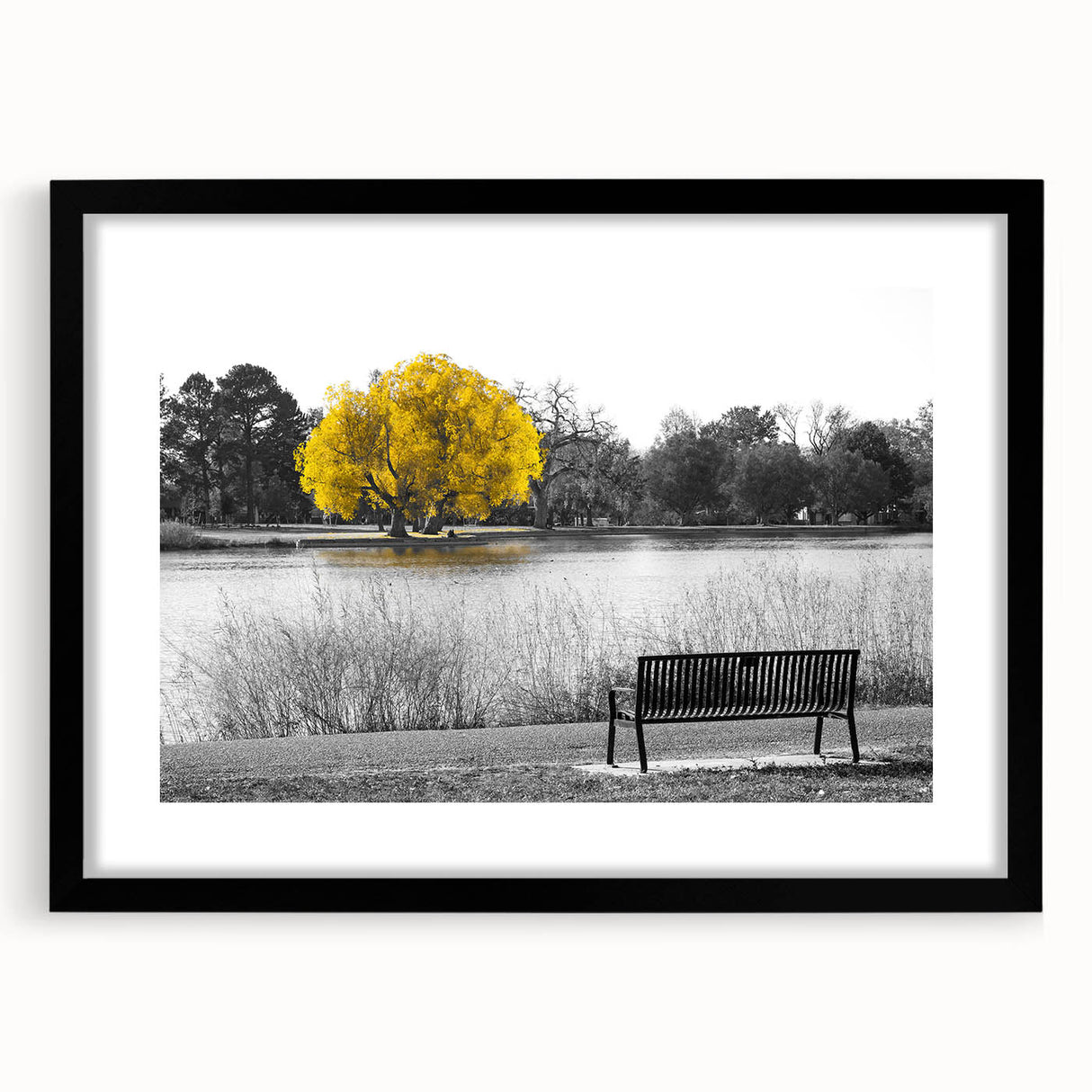 Black-framed wall art showcasing a serene landscape with a tranquil lake and lush trees, ideal for home decor and enhancing interior aesthetics.