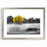 Framed wall art showcasing a serene lake landscape with lush greenery, elegantly presented in a silver frame with a mat, perfect for enhancing home decor.