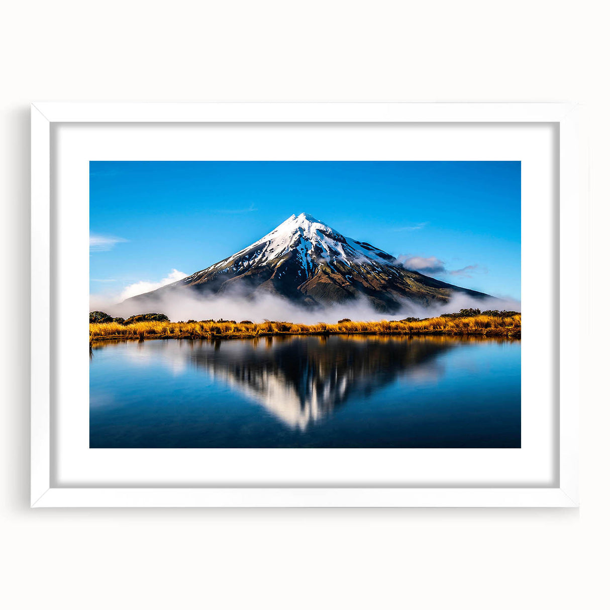 Framed wall art showcasing a serene landscape with a tranquil lake scene, featuring a white mat and frame, ideal for home decor and enhancing interior aesthetics.