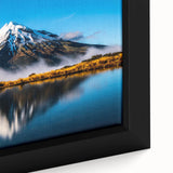 Framed canvas wall art featuring a serene landscape of a tranquil lake surrounded by lush greenery, showcasing vibrant colors and intricate details. Perfect for home decor.