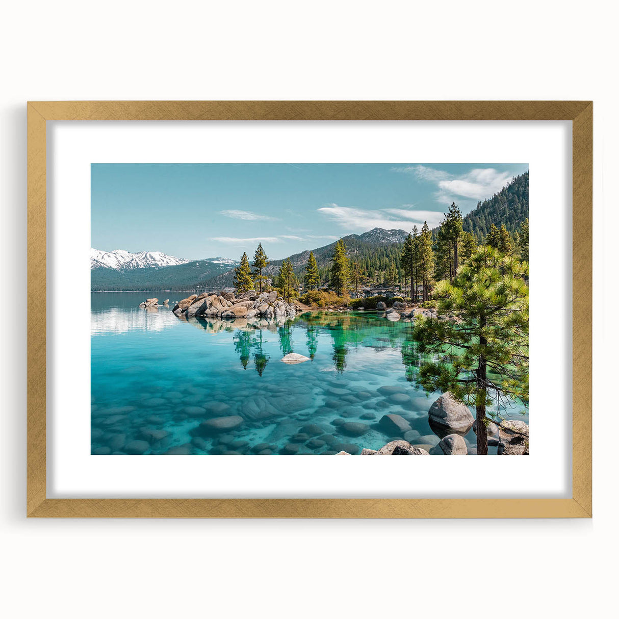 Framed wall art featuring a serene lake landscape with mountains in the background, elegantly presented with a gold mat, enhancing any home decor.
