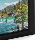 Close-up of a framed canvas artwork showcasing a serene lake landscape, featuring vibrant blues and greens, ideal for home decor and wall art enthusiasts.