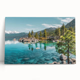 Stretched canvas artwork showcasing a serene lakeside landscape design with vibrant colors, elegantly leaning against a neutral wall, ideal for home decor.