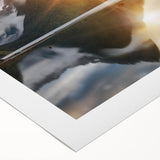 Rolled canvas artwork showcasing a serene lake landscape with vibrant colors, ideal for home decor, elegantly packaged in a protective tube for delivery.