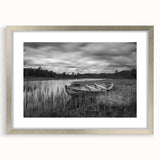 Framed wall art featuring a serene landscape with a tranquil lake, surrounded by lush greenery and soft clouds, presented in a sleek silver frame with a mat. Ideal for enhancing home decor with nature-inspired aesthetics.