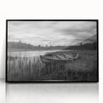 Framed wall art showcasing a serene landscape of a tranquil lake surrounded by lush greenery, presented in a sleek black frame, perfect for home decor enhancement.