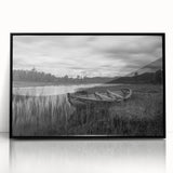Framed wall art showcasing a serene landscape of a tranquil lake surrounded by lush greenery, presented in a sleek black frame, perfect for home decor enhancement.