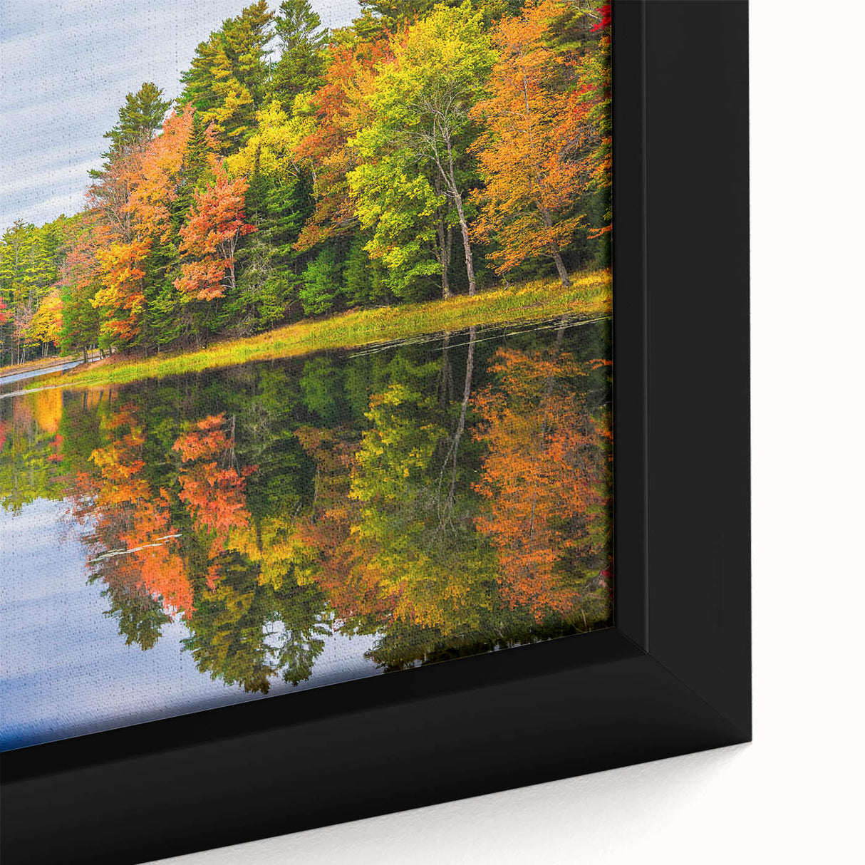 Close-up of a framed canvas wall art piece depicting a serene lake landscape at sunset, featuring vibrant colors and detailed textures, perfect for home decor.