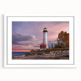 Framed wall art piece depicting a serene lighthouse landscape, featuring a white mat and modern design, perfect for coastal-themed decor in living spaces.