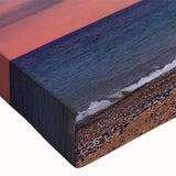 Close-up of a stretched canvas wall art piece featuring a vibrant lighthouse design against a serene seascape, emphasizing rich colors and intricate details. Perfect for coastal-themed decor.