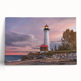 Stretched canvas wall art showcasing a serene lighthouse scene at sunset, with vibrant colors of orange and blue, perfect for coastal-themed decor.