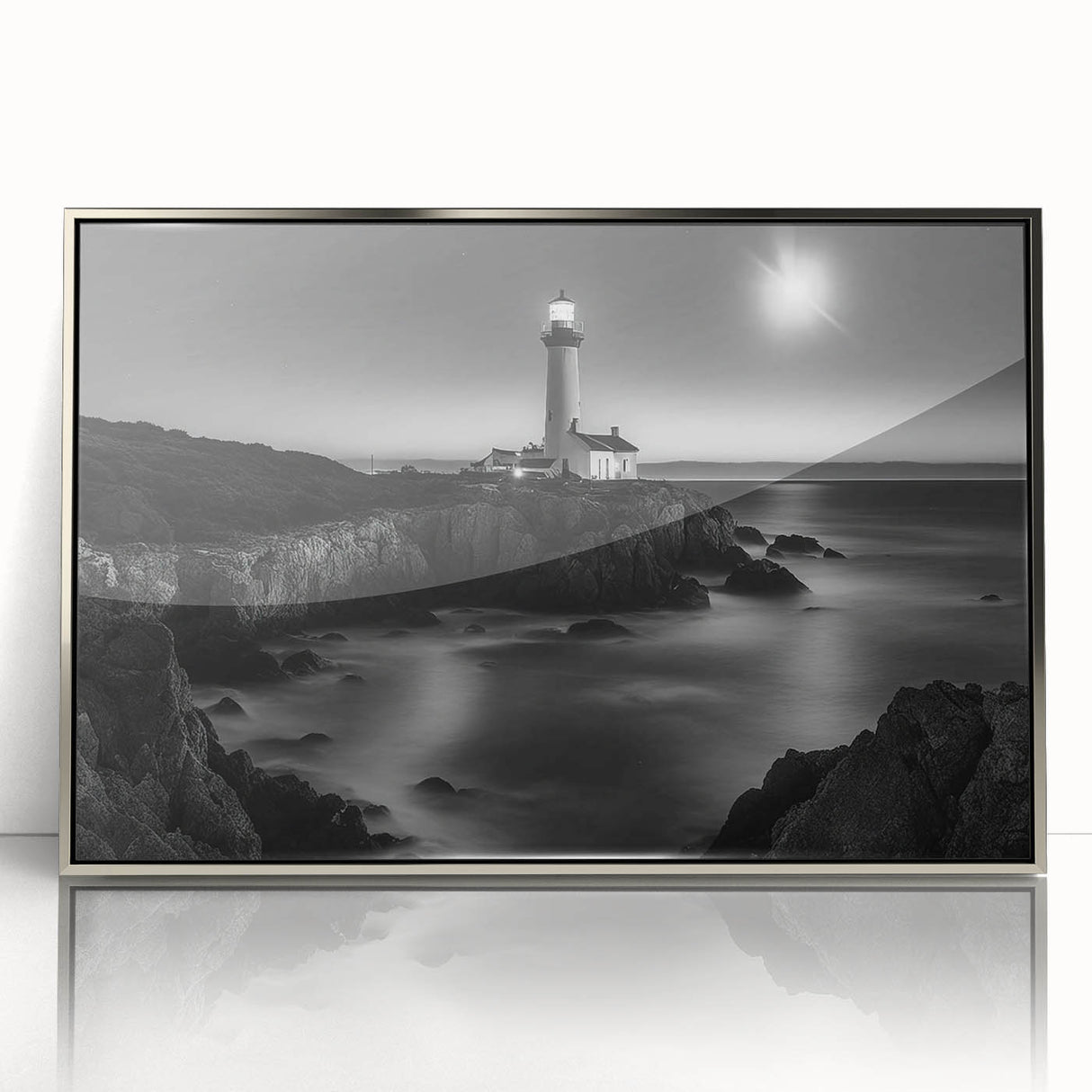Framed acrylic wall art featuring a silver lighthouse design, showcasing vibrant colors and intricate details, perfect for coastal-themed home decor.