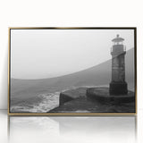 Framed wall art featuring a coastal lighthouse design in a gold frame, showcasing vibrant colors and intricate details against a serene landscape backdrop. Ideal for nautical-themed decor.