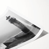 Vibrant rolled print showcasing a coastal lighthouse landscape, featuring rich hues of blue and orange, ideal for enhancing home decor with nautical themes.