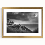 Elegant gold-framed wall art showcasing a serene lighthouse landscape design, complete with a white mat, perfect for home decor and coastal-themed interiors.