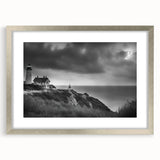 Framed silver wall art featuring a coastal lighthouse design, elegantly matted, ideal for enhancing home decor with a nautical theme. Perfect for living rooms or offices.