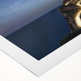 Rolled canvas artwork depicting a serene lighthouse landscape with vibrant colors, ideal for home decor, packaged securely in a protective tube for safe shipping.