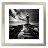 Framed wall art showcasing a serene lighthouse landscape design with a silver mat, perfect for coastal-themed decor. Ideal for enhancing home interiors with nautical charm.