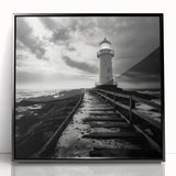Framed wall art featuring a serene lighthouse landscape design in vibrant colors, set against a black frame, ideal for coastal-themed home decor.