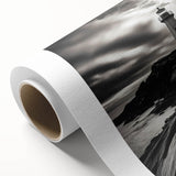 Vibrant rolled canvas artwork showcasing a scenic lighthouse landscape, perfect for home decor, featuring soft blues and warm sunset hues in a protective cardboard tube.