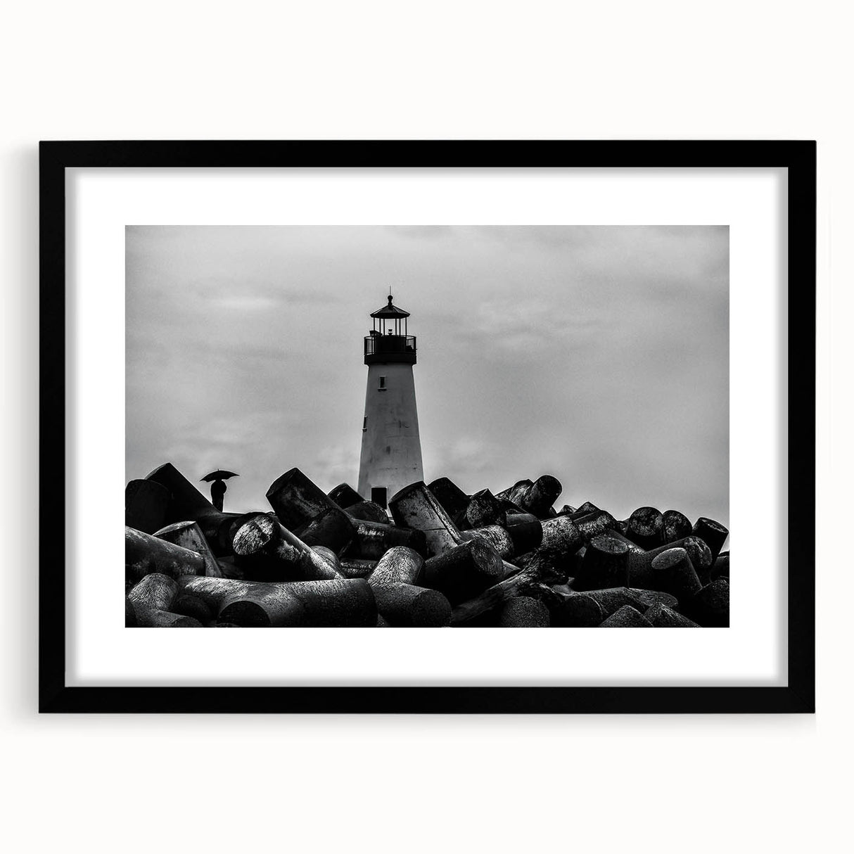 Framed landscape wall art featuring a serene lighthouse design with vibrant colors, black matting, and a sleek black frame, perfect for coastal-themed decor.