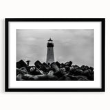 Framed landscape wall art featuring a serene lighthouse design with vibrant colors, black matting, and a sleek black frame, perfect for coastal-themed decor.