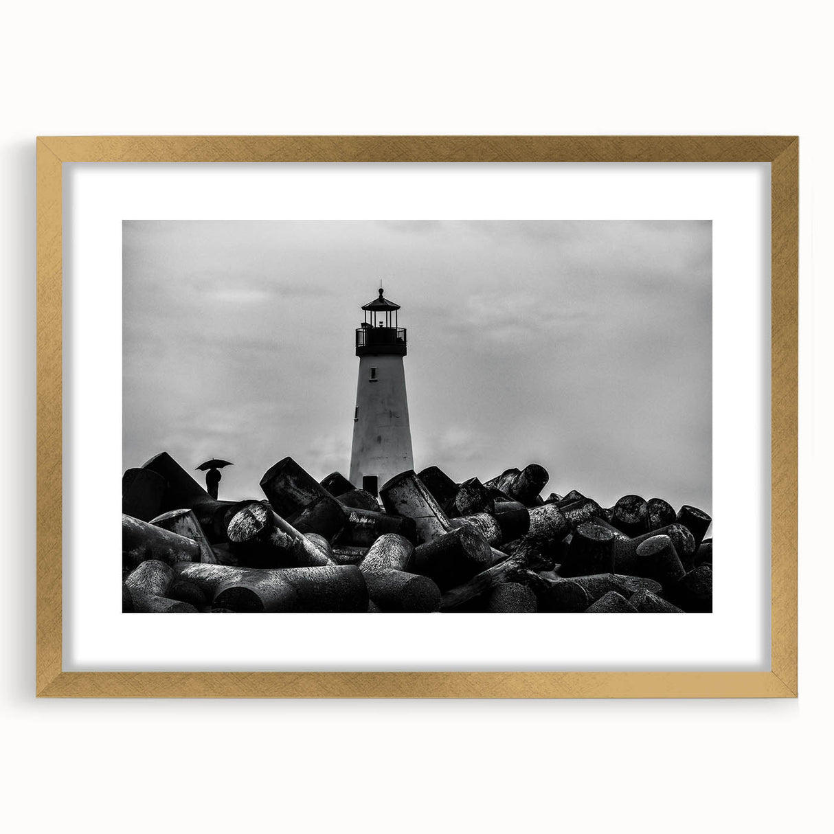 Golden-framed wall art featuring a serene lighthouse landscape design, complete with a mat, perfect for enhancing home decor with a coastal theme.
