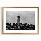 Golden-framed wall art featuring a serene lighthouse landscape design, complete with a mat, perfect for enhancing home decor with a coastal theme.