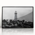 Framed wall art featuring a coastal lighthouse design, showcasing vibrant colors and intricate details in a black frame, perfect for home decor enthusiasts.