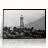 Framed wall art featuring a coastal lighthouse design, showcasing vibrant colors and intricate details in a black frame, perfect for home decor enthusiasts.