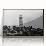 Framed wall art showcasing a serene lighthouse design in a coastal landscape, featuring a gold-acrylic finish that enhances its vibrant colors and adds elegance to any decor.