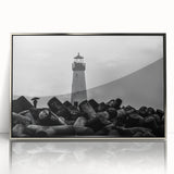 Framed acrylic wall art featuring a striking lighthouse design with a silver border, ideal for coastal-themed decor. Perfect for adding a touch of elegance to any room.
