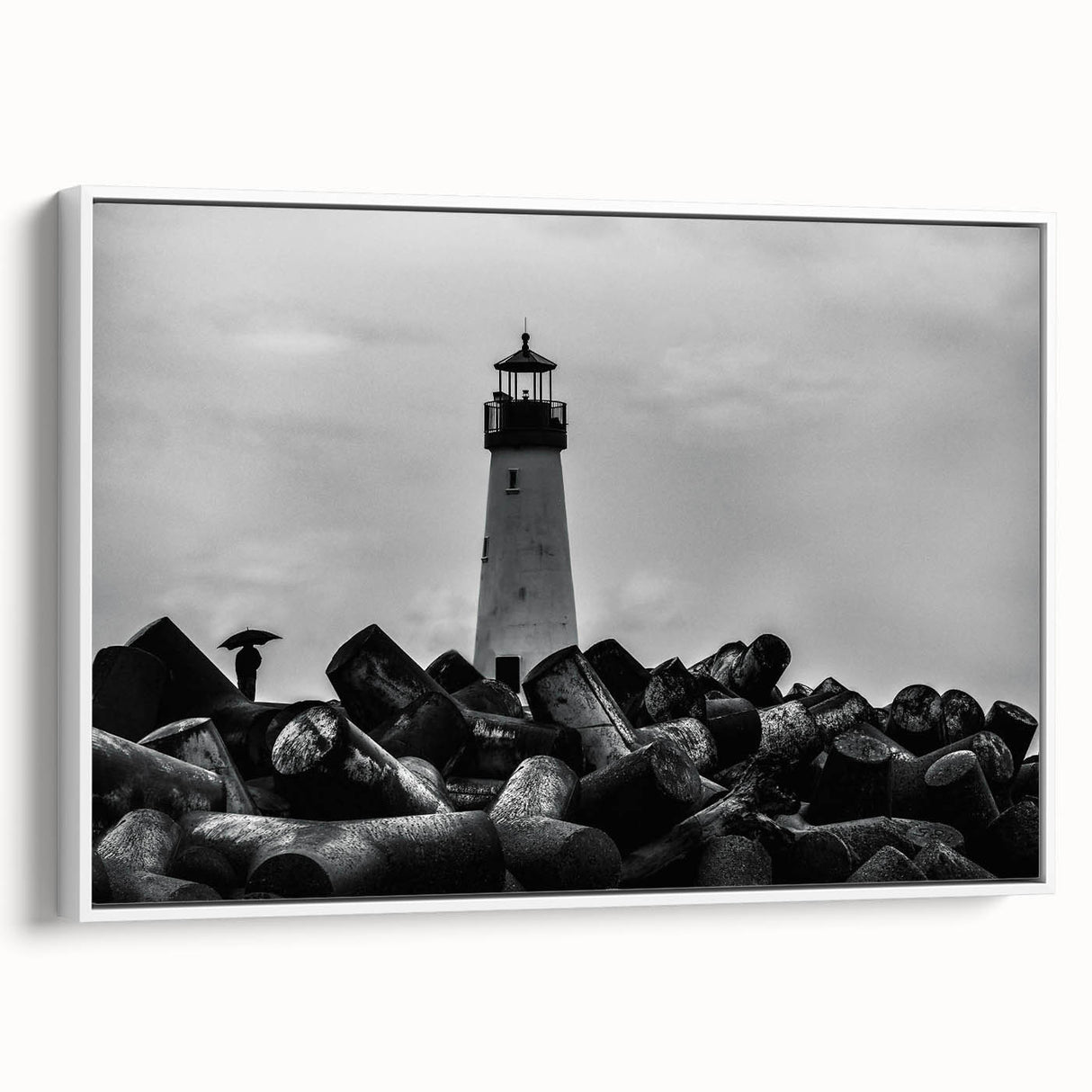 Framed canvas wall art depicting a serene lighthouse landscape design in soft blue and white tones, showcasing coastal tranquility and modern decor style.
