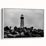 Framed canvas wall art depicting a serene lighthouse landscape design in soft blue and white tones, showcasing coastal tranquility and modern decor style.
