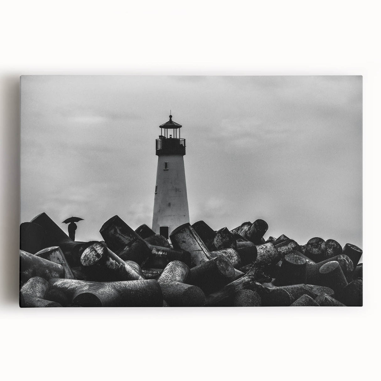 Stretched canvas wall art showcasing a vibrant coastal landscape with a lighthouse, waves crashing against rocks, and a colorful sunset sky, perfect for home decor.