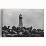 Stretched canvas wall art showcasing a vibrant coastal landscape with a lighthouse, waves crashing against rocks, and a colorful sunset sky, perfect for home decor.
