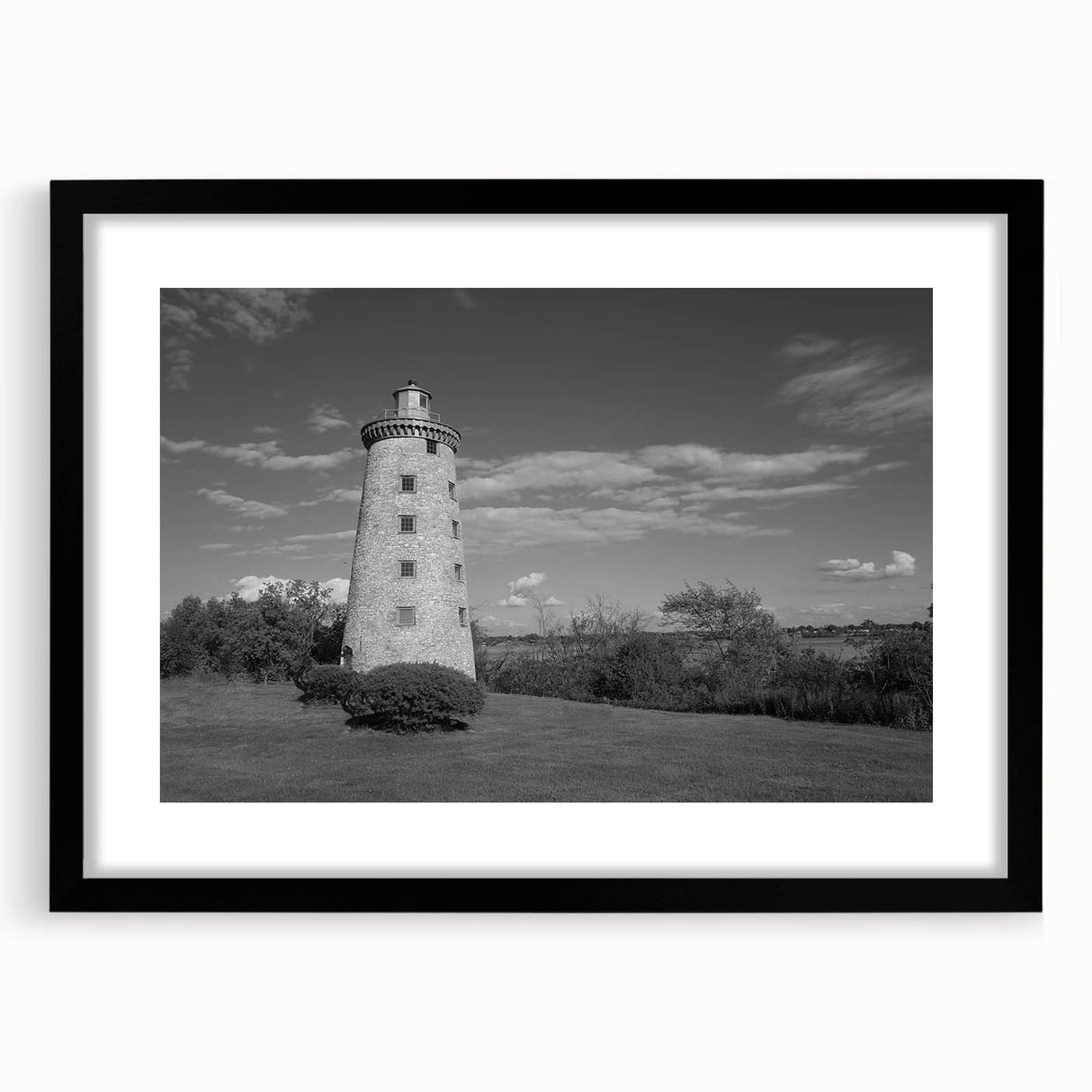 Framed wall art collection showcasing a serene lighthouse landscape design with a black mat and frame, perfect for coastal-themed decor.