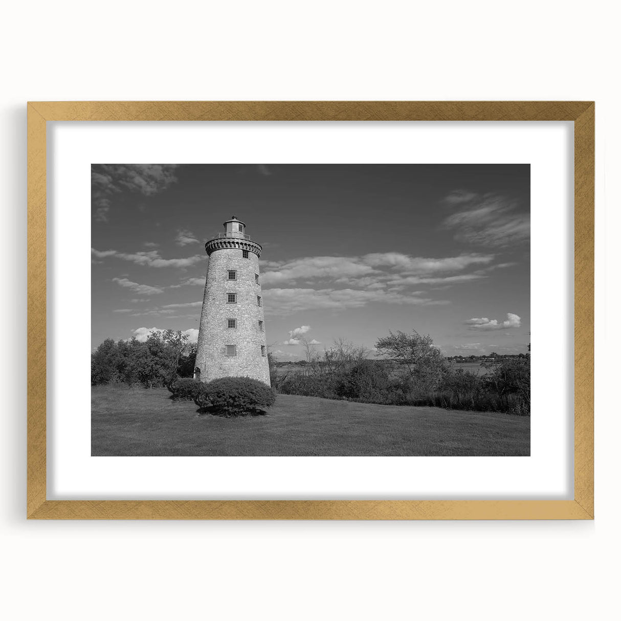 Framed wall art collection featuring a scenic lighthouse landscape design with a gold mat and frame, ideal for coastal-themed home décor and interior design.
