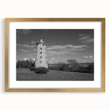 Framed wall art collection featuring a scenic lighthouse landscape design with a gold mat and frame, ideal for coastal-themed home décor and interior design.