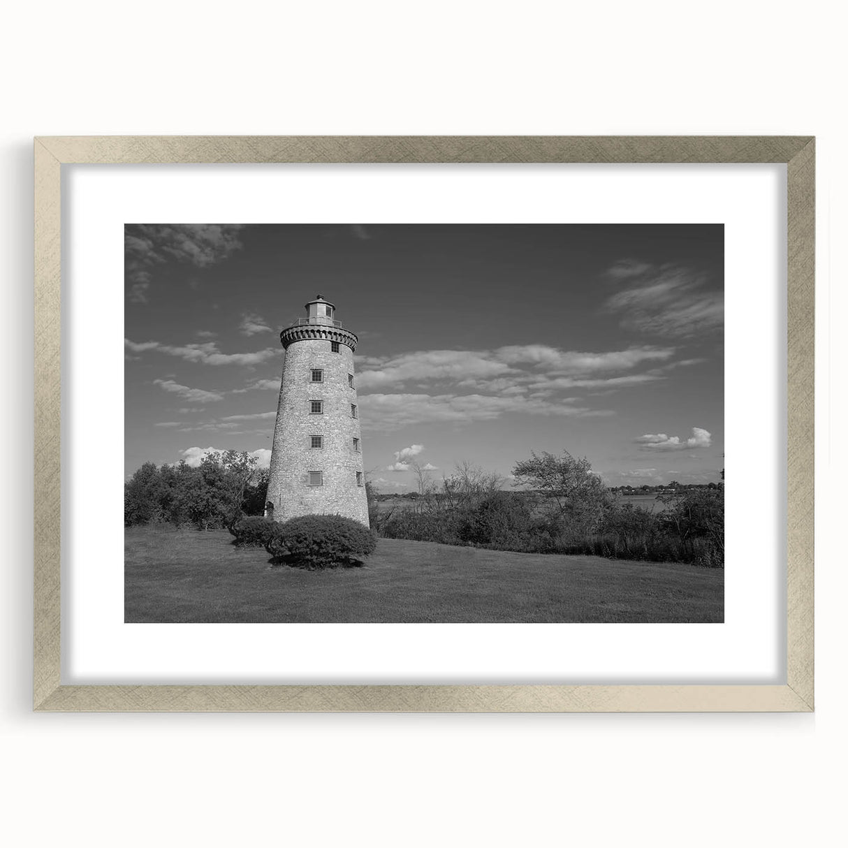 Framed silver wall art collection featuring a serene lighthouse landscape design, elegantly matted, perfect for enhancing coastal-themed interiors.