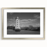 Framed silver wall art collection featuring a serene lighthouse landscape design, elegantly matted, perfect for enhancing coastal-themed interiors.