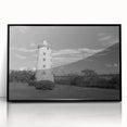 Framed wall art featuring a coastal lighthouse design in vibrant colors, showcasing a serene seascape with blue skies and waves, perfect for home decor.