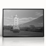 Framed wall art featuring a coastal lighthouse design in vibrant colors, showcasing a serene seascape with blue skies and waves, perfect for home decor.