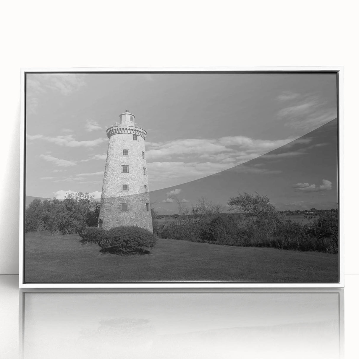 Framed wall art featuring a serene coastal landscape with a lighthouse, vibrant colors, and soft clouds, perfect for enhancing home decor and bringing a nautical theme to any space.
