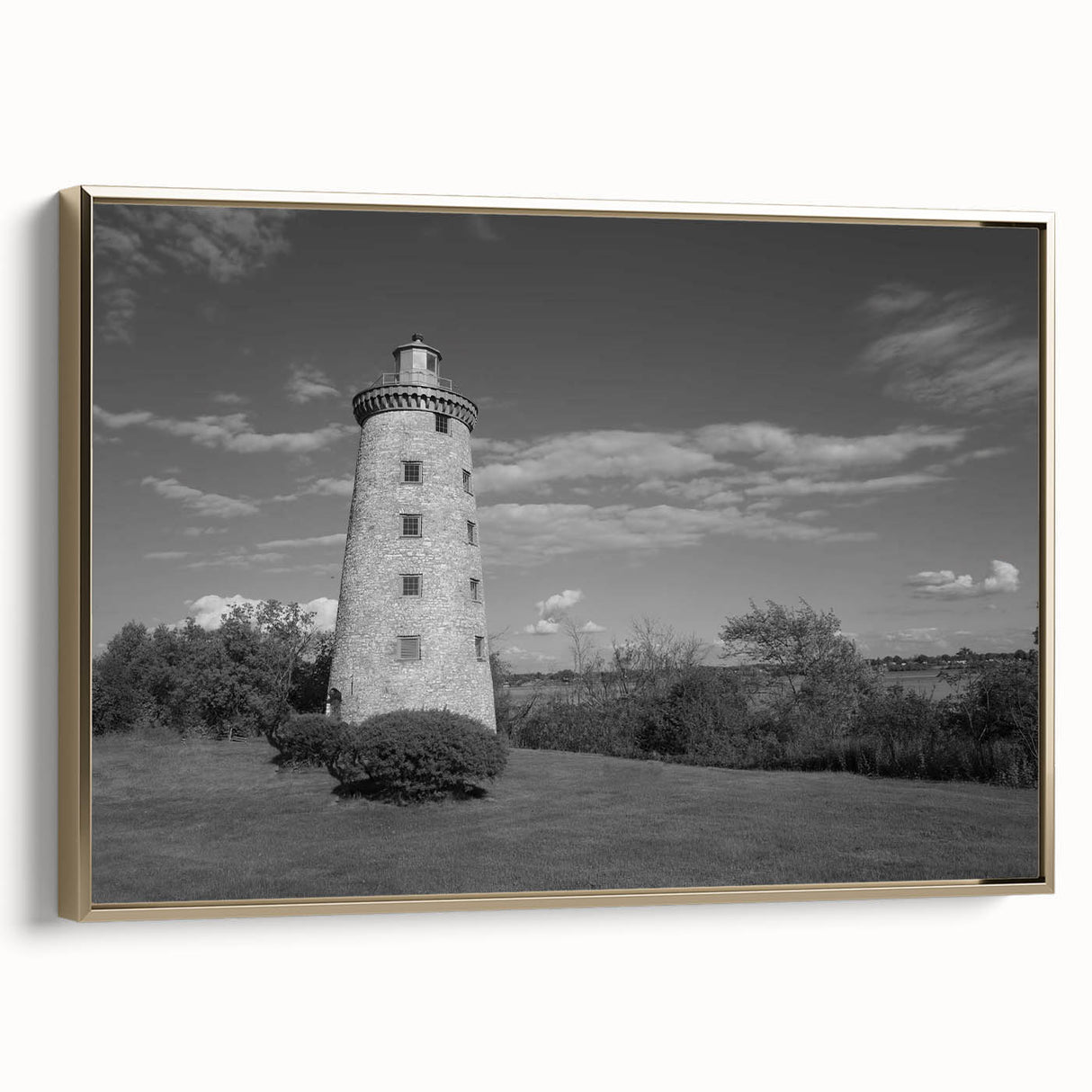Framed canvas wall art showcasing a stunning lighthouse design with gold accents, set against a serene landscape background, ideal for coastal decor enthusiasts.